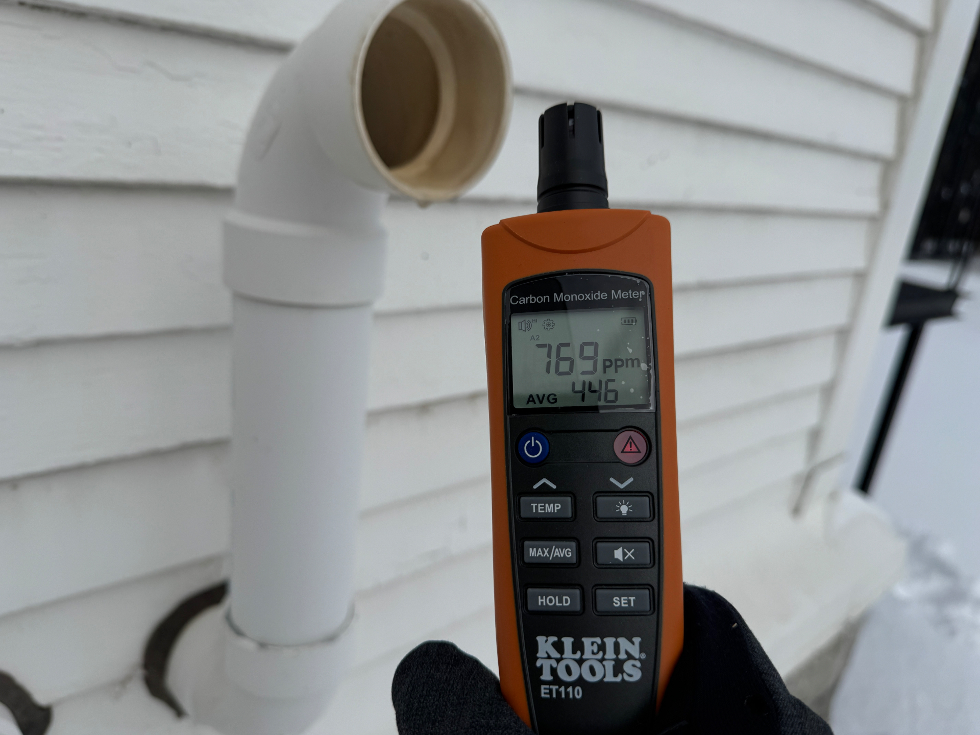 Klein Tools ET110 carbon monoxide meter reading 769 ppm at exhaust vent during a consulting visit