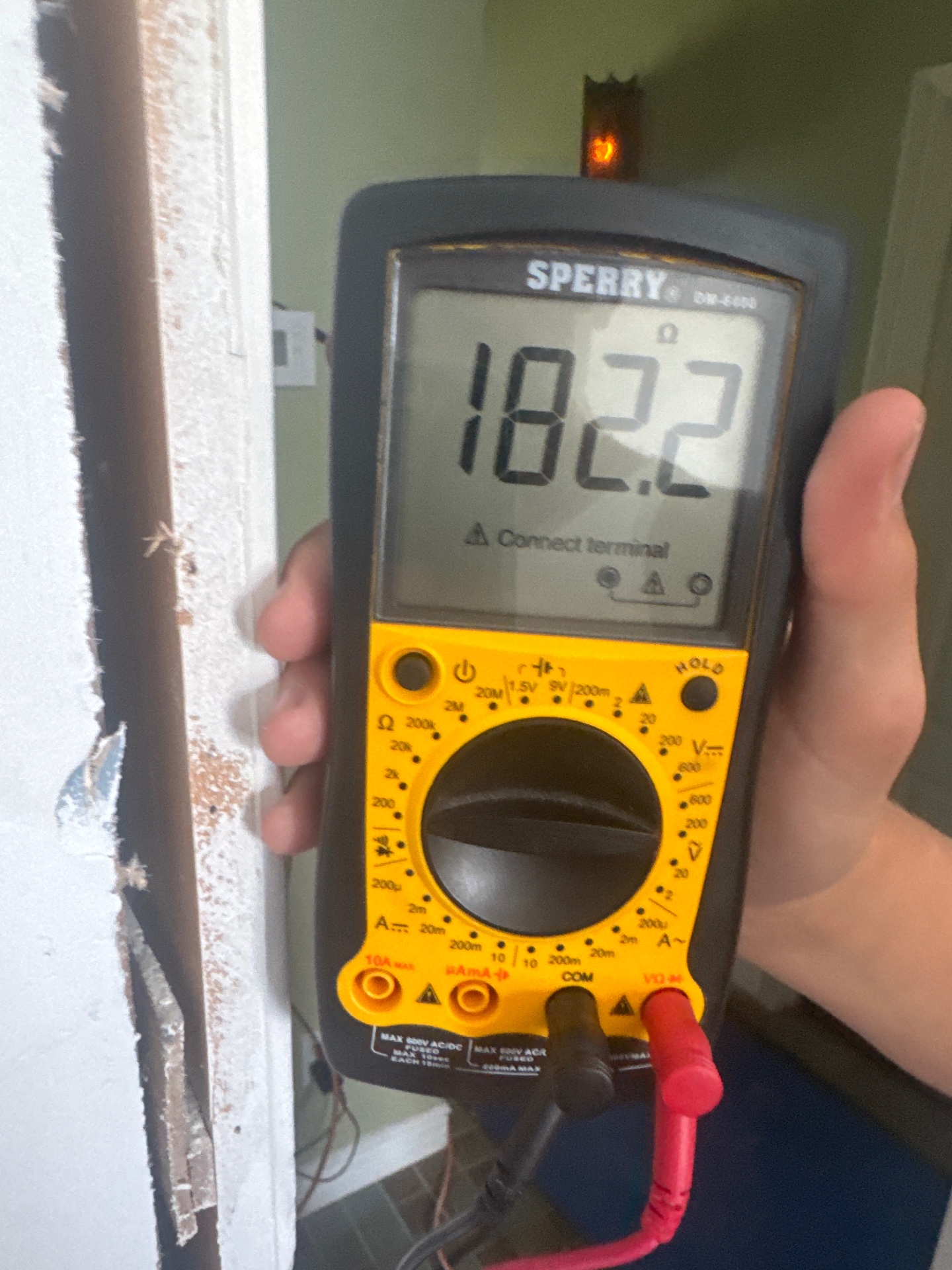Sperry digital multimeter measuring resistance during an electrical advisory visit