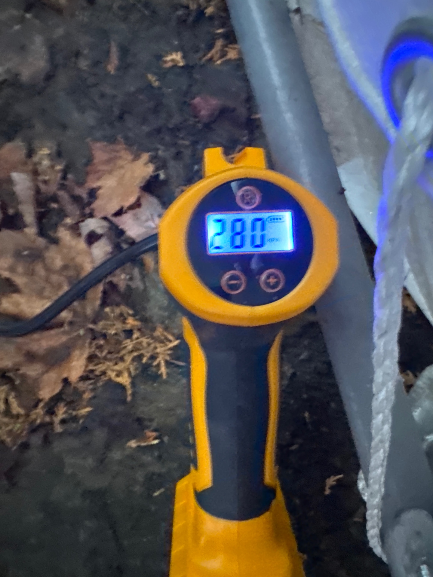 Digital pressure gauge reading 280 kPa during a plumbing pressure test