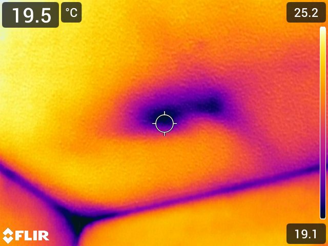 FLIR thermal imaging revealing hidden moisture intrusion in ceiling corner during a consulting visit