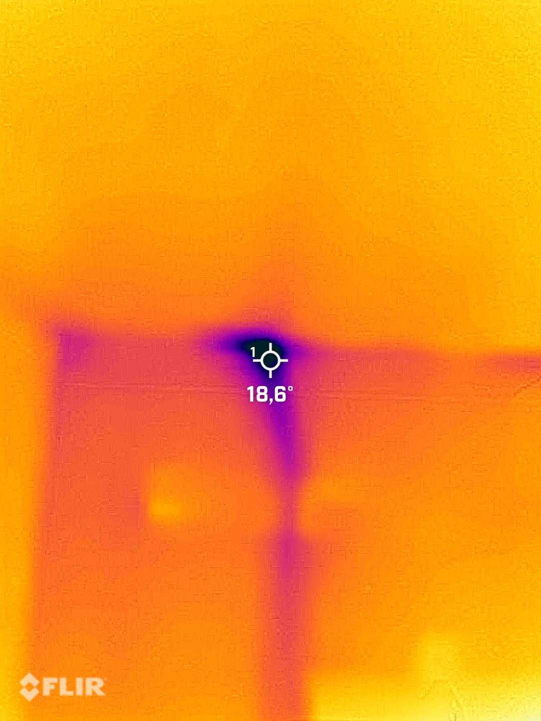 FLIR thermal scan showing cold spot and missing insulation behind interior wall